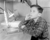 Boy sitting at desk with model missile Poster Print - Item # VARSAL255424645