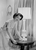 Young woman cleaning side table Poster Print - Item # VARSAL255420087