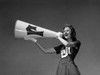 Low angle view of a female cheerleader shouting into a megaphone Poster Print - Item # VARSAL25515940