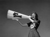 Low angle view of a female cheerleader shouting into a megaphone Poster Print - Item # VARSAL25515940