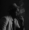 Studio portrait of man wearing hat  smoking cigarette Poster Print - Item # VARSAL2556674