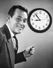 Portrait of a businessman in front of a clock smiling Poster Print - Item # VARSAL25548079
