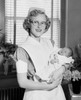 Portrait of a female nurse carrying a newborn baby boy Poster Print - Item # VARSAL2557967