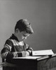 Boy writing with a pencil on a notepad Poster Print - Item # VARSAL2553233B