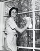 Portrait of a young woman cleaning the glass of a window Poster Print - Item # VARSAL25541929
