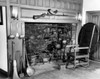 Fireplace tools and an armchair in room with fireplace Poster Print - Item # VARSAL25535971