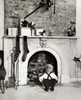 Rear view of a boy crouching near a fireplace Poster Print - Item # VARSAL25525147