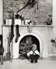 Rear view of a boy crouching near a fireplace Poster Print - Item # VARSAL25525147