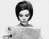 Close-up of a young woman reading a newspaper Poster Print - Item # VARSAL25541866