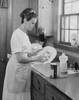 Young woman washing dishes in kitchen Poster Print - Item # VARSAL25541752