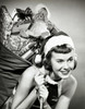 Close-up of a young woman carrying a sack of Christmas presents on her back Poster Print - Item # VARSAL25516085B
