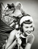 Close-up of a young woman carrying a sack of Christmas presents on her back Poster Print - Item # VARSAL25516085B