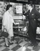 Mid adult woman talking to mature man in store Poster Print - Item # VARSAL25543676