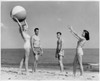 Two young couples playing with beach ball on beach Poster Print - Item # VARSAL2553429