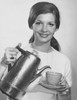 Portrait of a young woman pouring tea from a kettle Poster Print - Item # VARSAL25541755