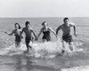 Two young couples running in water Poster Print - Item # VARSAL2553428