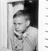 Sad boy looking through window Poster Print - Item # VARSAL255417700 Sad boy looking through window Poster Print - Item # VARSAL255417700