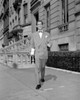 Young man walking on sidewalk Poster Print - Item # VARSAL255417965