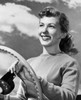 Close-up of a young woman holding the steering wheel of a car and smiling Poster Print - Item # VARSAL2557895A