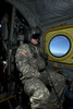 Crew chief looking out the window of a CH-47 Chinook while in flight to Playas Training Area, New Mexico, during exercise Angel Thunder 2013 Poster Print - Item # VARPSTTMO101131M