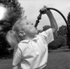 Girl drinking from garden hose Poster Print - Item # VARSAL255416406