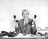 Portrait of a businessman holding two telephone receivers Poster Print - Item # VARSAL25527996
