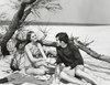 Young couple sitting on the beach Poster Print - Item # VARSAL25522080