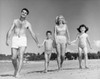 Mid adult couple with children walking on beach Poster Print - Item # VARSAL2553147B