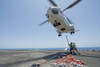 Gulf of Oman, September 5, 2013 - A Sailor and a Marine attach a cargo hook to an SA-330J Puma helicopter aboard the amphibious assault ship USS Kearsarge during a vertical replenishment. Poster Print - Item # VARPSTSTK107811M