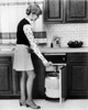 Side profile of a young woman putting a can in a garbage bin Poster Print - Item # VARSAL25541963