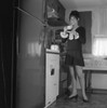 Woman drinking tea in kitchen Poster Print - Item # VARSAL255420955