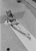 Young woman in swimwear lying on diving board Poster Print - Item # VARSAL255419031