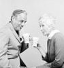 Senior couple drinking and looking each other Poster Print - Item # VARSAL25548860