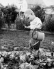 Side profile of a boy watering plants Poster Print - Item # VARSAL255242