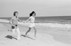 Young couple running across beach Poster Print - Item # VARSAL255422372