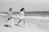 Young couple running across beach Poster Print - Item # VARSAL255422372 Young couple running across beach Poster Print - Item # VARSAL255422372