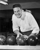 Young adult man choosing bowling ball Poster Print - Item # VARSAL2558888A