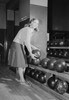 Smiling young woman holding bowling ball Poster Print - Item # VARSAL255418459