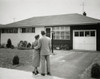 Rear view of a man and a woman standing in front of a house Poster Print - Item # VARSAL2553514