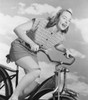 Young woman riding bicycle against cloudy sky Poster Print - Item # VARSAL255422993A