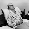 Mature man reclining on the bed with an ice pack on his head Poster Print - Item # VARSAL25533137