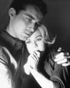 Close-up of a young man embracing a young woman and looking serious Poster Print - Item # VARSAL2557608