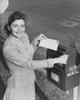 Young woman dropping a letter into a mailbox Poster Print - Item # VARSAL25532626