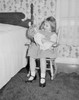 Girl playing with doll beside bed Poster Print - Item # VARSAL255422204