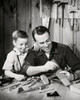Father repairing model airplane while son standing beside him Poster Print - Item # VARSAL2553165
