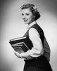 Teenage girl carrying stack of books and smiling Poster Print - Item # VARSAL2552152A