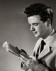 Side profile of a young man reading a newspaper Poster Print - Item # VARSAL25542673
