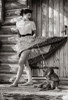 Young woman standing in front of her house with her dog Poster Print - Item # VARSAL2551486