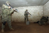 Marines hold an SASO instructor down while checking him to see if he has any hidden weapons or any item that can harm the Marines during a vehicle checkpoint exercise in the SASO course Poster Print - Item # VARPSTSTK102526M