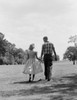 Young couple holding hands and walking Poster Print - Item # VARSAL255419361